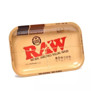 A rectangular, cardboard rolling tray with a brown and white leaf pattern, used for rolling cigarettes or other tobacco products. It is sold as Large Rolling Tray - RAW on a smoking company website.