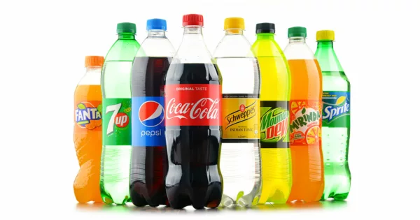 Line of colorful plastic soda bottles with different designs on a white background - Soda Drink.