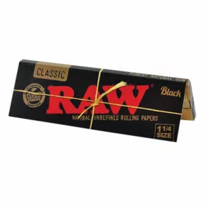 Black 1 1/4 size rolling papers by RAW, packaged in cardboard with white 'RAW' letters on front, tied with twine.