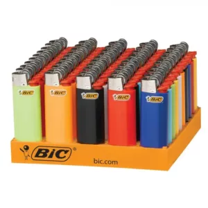 Six colorful rectangular BIC lighters in a mix of orange, green, yellow, purple, and blue, displayed on an open rack with the brand name written in large letters.