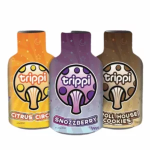 Four glass bottles of Trippi in different sizes with light blue and white labels and colored caps. Also includes two smaller bottles with the same design.