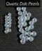 These clear, round quartz pearls are smooth, shiny, and blemish-free, likely to be used in jewelry or decorative items. The well-lit image showcases their elegance and sophistication.