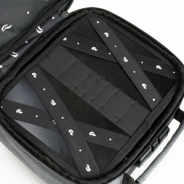 Black suitcase with white polka dots, zippered closure, and two handles.