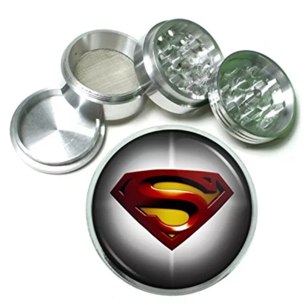 Silver metal grinder with Superman logo on circular body, handle on top and small opening on bottom.