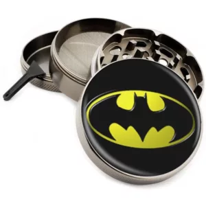 durable metal grinder with a circular shape and a batman logo in the center. It is designed to grind herbs and smoking materials into a fine powder.