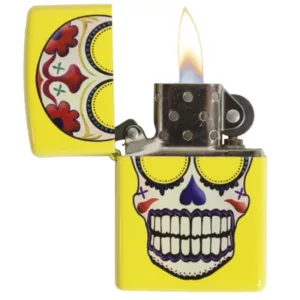 Colorful skull design on a flat rectangular Zippo lighter with a bright yellow-orange flame. Day of the Dead style.