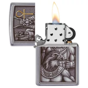 Etched silver lighter with intricate design featuring an eagle and serpent, symbolizing Egyptian gods, from Zippo smoking company.