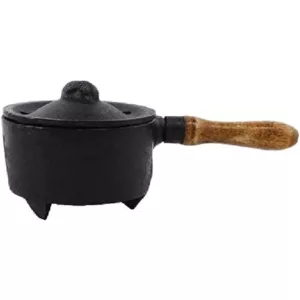 Handcrafted wooden cauldron incense burner with cast iron bowl and curved wooden handle. Mounted on a decorative wooden stand with four legs.