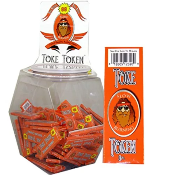 Orange tokens with golden bearded man design in clear plastic container. Stacked neatly and sitting on white background.