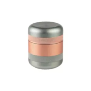 Kannastor's Tiny GR8TR canister is made of aluminum with a copper-colored anodized coating, has a screw-on lid, and a gold ring on top. It's a rectangular, cylindrical canister with a circular base and a shiny silver finish.