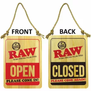 Image of wooden Raw Open and Raw Closed signs hanging from a rope. Rectangle shape with diagonal line, black ink writing.