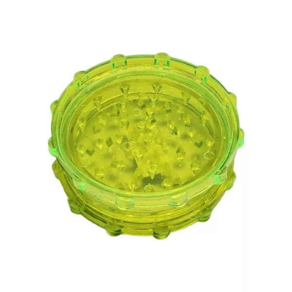 Yellow acrylic grinder with clear base, small yellow circles on top and center hole.