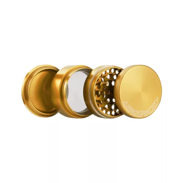 Gold grinder with black base, circular shape, handle, and 4 circular openings. Higher Standards brand.
