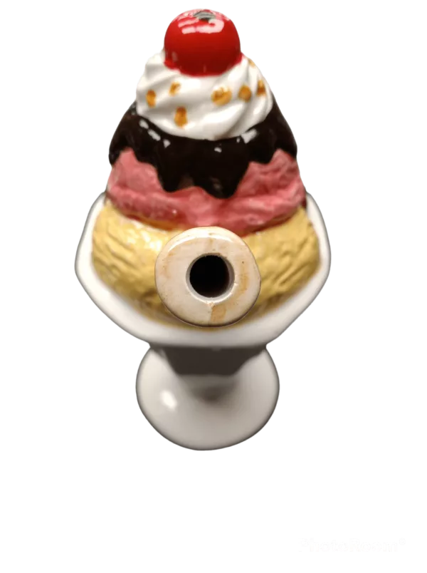 Indulge in rich chocolate, sweet strawberries, and creamy whipped cream in our Ice Cream Sundae Pipe - Roast & Toast. Served in a small bowl with a cherry-topped wooden spoon, it's the perfect treat for any occasion.
