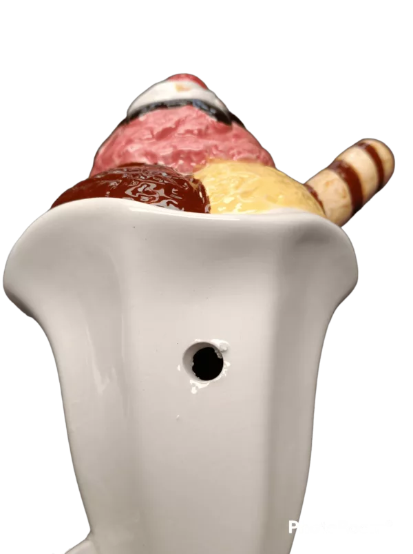 A white ceramic bowl with a brown and white swirl pattern, used for smoking ice cream, known as the Ice Cream Sundae Pipe by Roast & Toast.