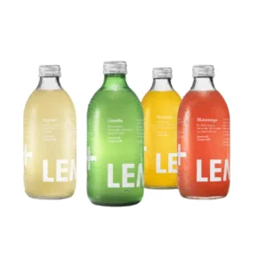 Four 250mL bottles of Lemonaid, displayed on a white background with clear, green or yellow plastic bodies and silver caps. The bottles feature white labels with the word 'lemonade' written in white.