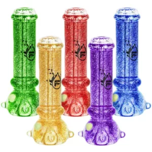 Experience a colorful, glittery journey with the Glycerin Series Glitter Taster Bat - Pulsar. Five tubers in a circle, connected to a larger tube with a black handle and purple glitter tip. Each tuber has a unique colored handle and a small glittery dot on top. Perfect for any smoking experience.