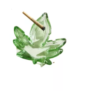 Leafy Ashtray with clear glass leaf design, wide base, and small white base. Features a round hole with raised rim and textured grooves.