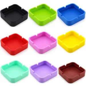 The Square Silicone Ashtray from NNS629 is a durable, plastic ashtray with a smooth surface and six different colors. It is suitable for indoor and outdoor use and can hold cigarettes, matches, and other small objects.