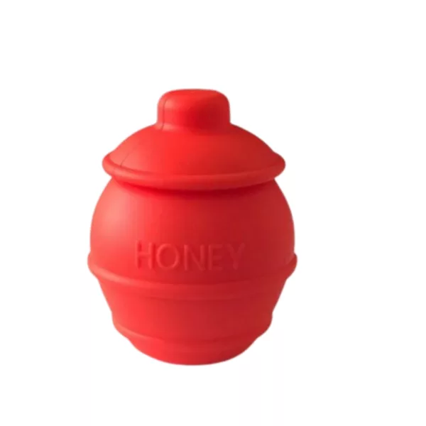 Silicone honey jar with white honey labeling, round shape, wide mouth, and screw-on lid. Brightly lit and clear colors.