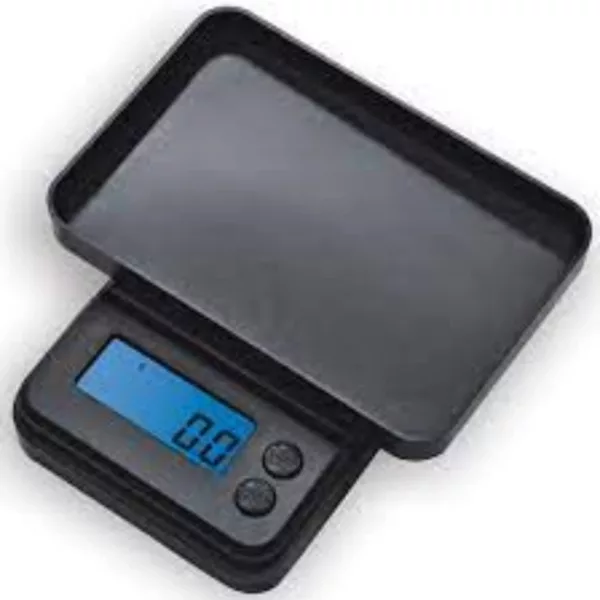A small, black scale with clear display and plastic case. Shows weight of object and has an on/off button. White background.