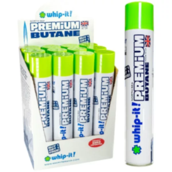 White & green labeled 'Whip it Premium Butane' display case with blue arrow & clear window. Plastic exterior with white/green border.