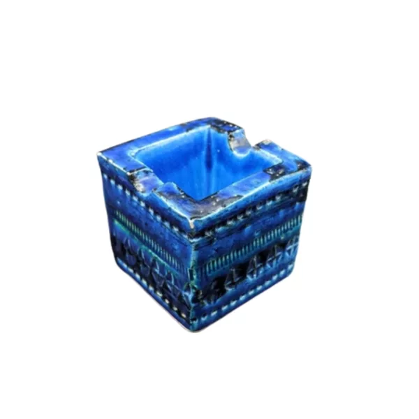 A unique, blue glazed ceramic cube ashtray with intricate, nature-inspired designs on a smooth surface. Perfect for decorating or as a statement piece in a smoking area.