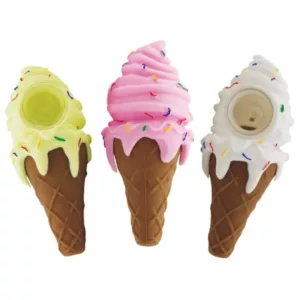 Three pink silicone ice cream cone-shaped hand pipes with white and brown specks, displayed on a white background.