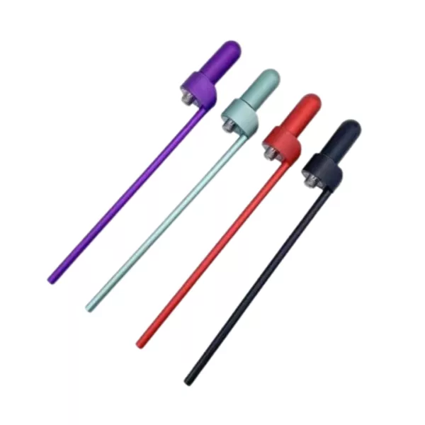 Four plastic straws (purple, blue, green, red) in a row, long and thin, with small plastic tips. Arranged in a line, pointing downwards.