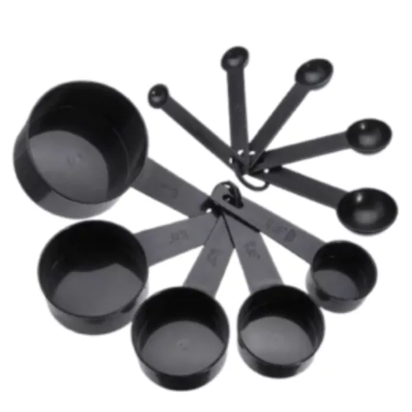 Six black plastic measuring spoons with white dots and t handles, including 1 tsp, 1 tbsp, and 4 tbsp sizes.