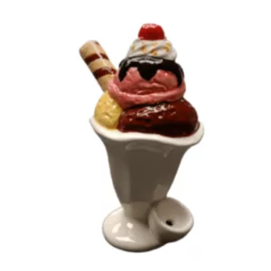 A colorful ice cream sundae pipe featuring a white ceramic cone with chocolate and vanilla scoops, whipped cream, and cherries.