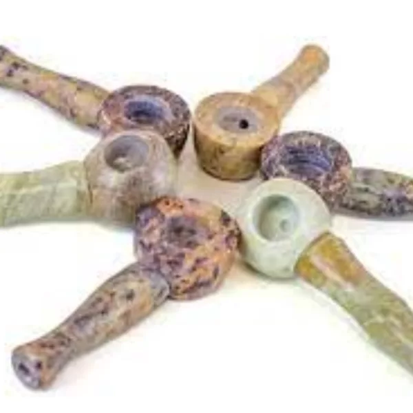 Handcrafted stone pipe with brown/green rings, white handle, and small crack. Displayed on white background. APP3290.