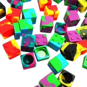 Multicolored Lego silicone containers in various shapes and sizes, forming a pile on a white background.