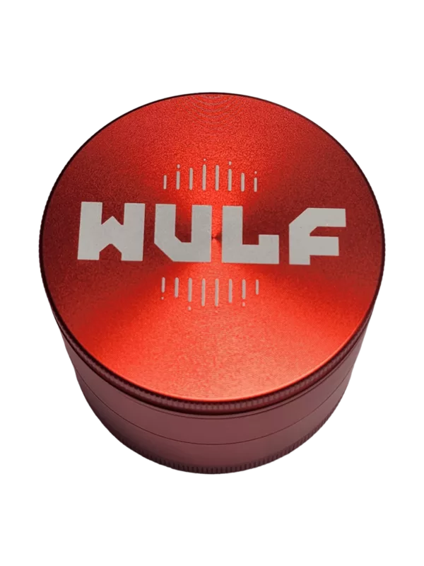 Functional red metal grinder with 'Wulf' logo, suitable for smoking. Well-lit image.
