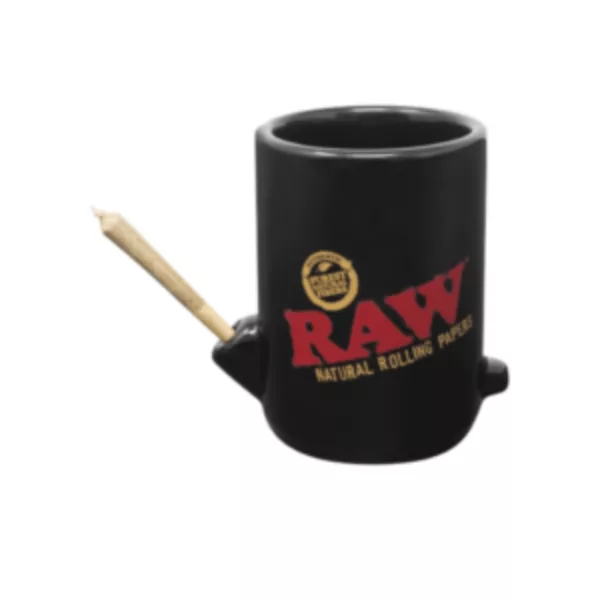 A black ceramic mug with white rim and handle, featuring Raw logo on it, on a black background.