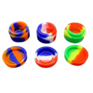 Set of six colored plastic cups with abstract geometric designs. Transparent, different colors (blue, red, yellow, green, orange). Symmetrical pattern, stacked on top of each other. Same size and shape, flat bottom, slightly raised rim. White background.