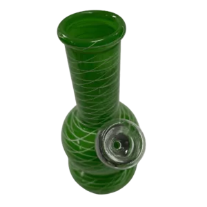 Swirled glass bong with clear base and green neck. Small circular mouthpiece on end. White background.