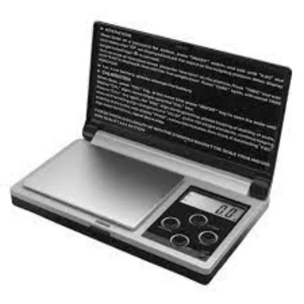 Small black and silver electronic scale with display screen, suitable for weighing in grams and kilograms.