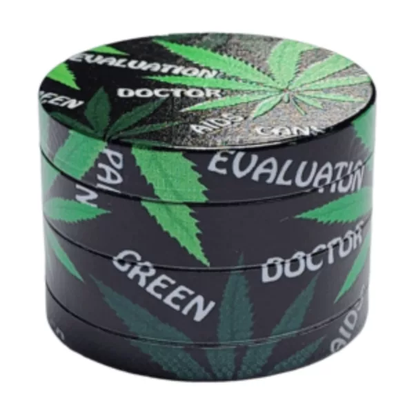 round container with a black background and a green marijuana leaf design on it. It has a small hole on the top and bottom and is made of plastic. It is not clear what the container is used for.
