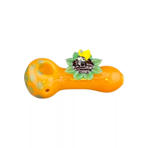 Orange and yellow smoking pipe with green leaf and orange band, featuring a yellow flower with orange petals.
