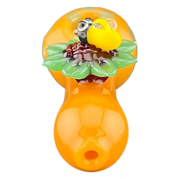 Glass smoking pipe with yellow sunflower design, orange stem and bowl, flat bottom and rounded edges.