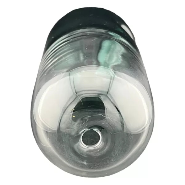 A clear glass bottle with a black cap, sitting on a white background, appears to be empty and in good condition.