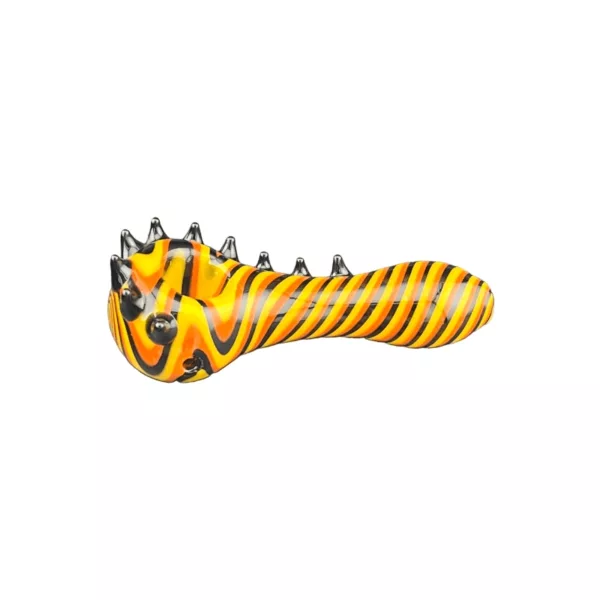 Glass tiger shaped pipe with yellow and black stripes, round base and sharp spikes on end. Symmetrical with clear background.