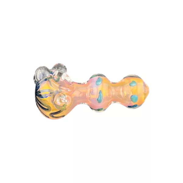 Glass turtle pipe with yellow and blue design, small hole at end, sits on white background.