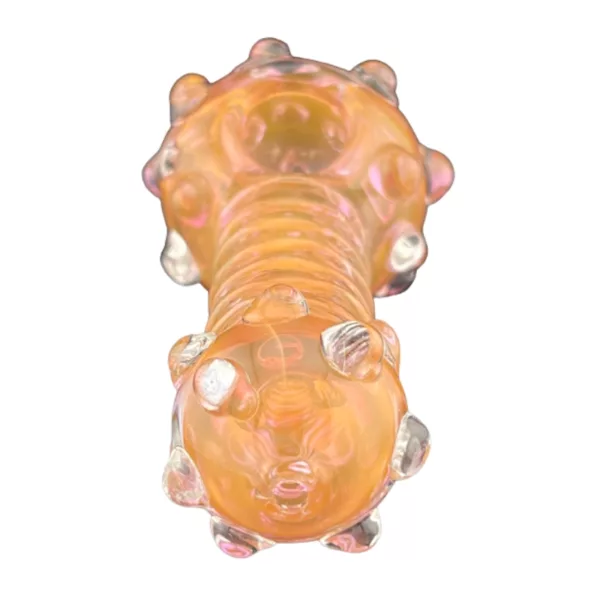 A clear glass pipe with a small, round orange bead on the end, sitting on a white background.