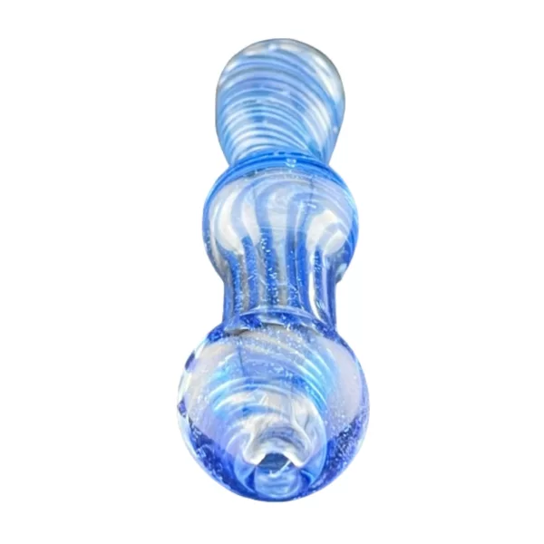 A blue glass chillum with a swirled design and small holes, sitting on a white surface with some dirt.
