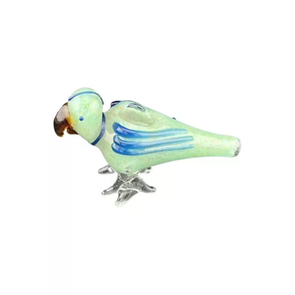 small bird with blue and green feathers, perched on a branch with a twig in its beak. It has a long curved beak and spread wings, with closed eyes.