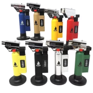 Set of 6 colorful plastic lighters on a black stand, plugged in and with one showing flame. Brightly lit image.
