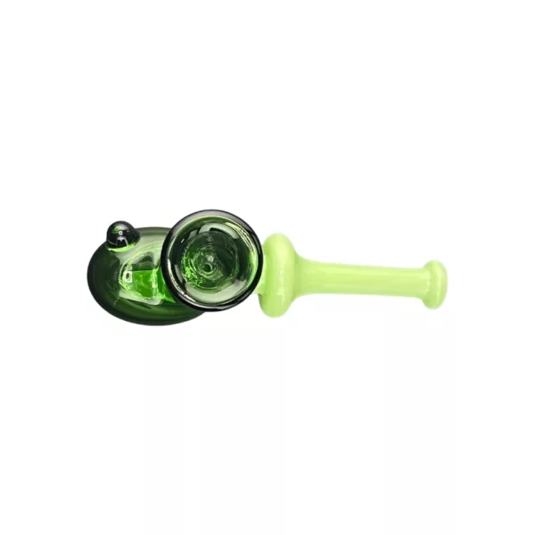 Green glass pipe with small, round base and long, curved stem made of clear plastic. Base has small, round hole surrounded by green glass etched with circular patterns. Pipe sits on white background.