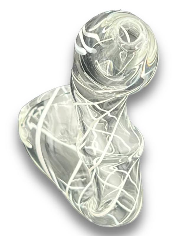 glass object in the shape of a human figure, standing on one leg and holding something in its hand. The image is shot from a low angle and the background is black.